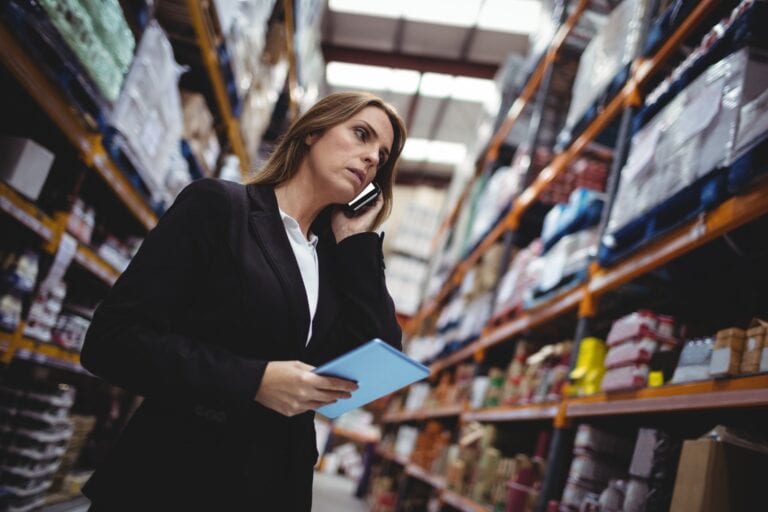 Businesswoman on a phone call in warehouse