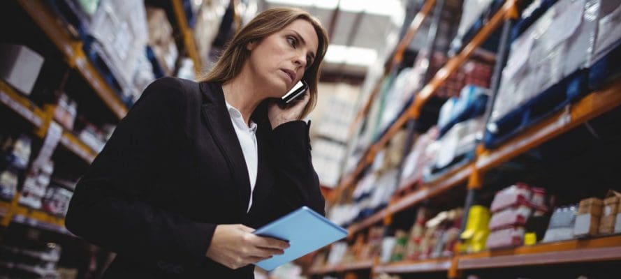 Businesswoman on a phone call in warehouse